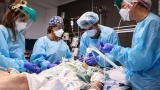 8 states account for half of US Covid-19 hospitalizations. And the surge is overwhelming health care workers