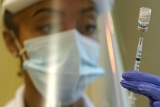 CDC leader adds people with risky jobs to COVID booster list