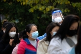 China eases some quarantine for travelers even as cases rise