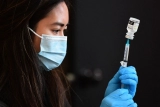 Biden officials push to offer second booster shot to all adults