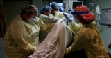U.S. COVID peak may be over but not the pain as deaths rise