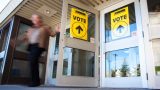 What COVID-19 precautions are being taken on voting day?